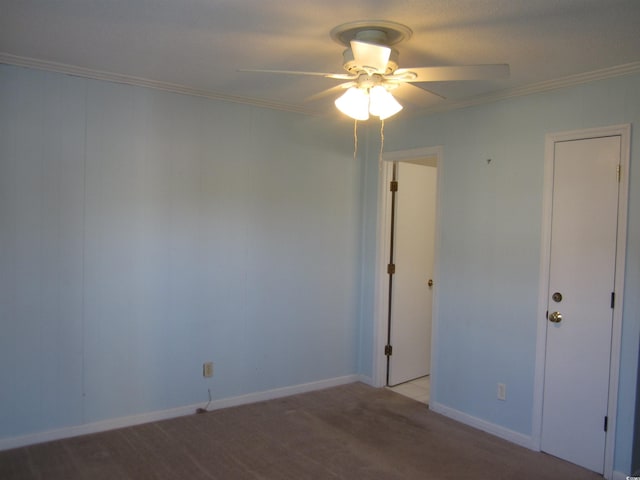 carpeted empty room with crown molding and ceiling fan