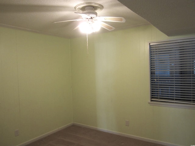 unfurnished room featuring a textured ceiling, carpet floors, ornamental molding, and ceiling fan