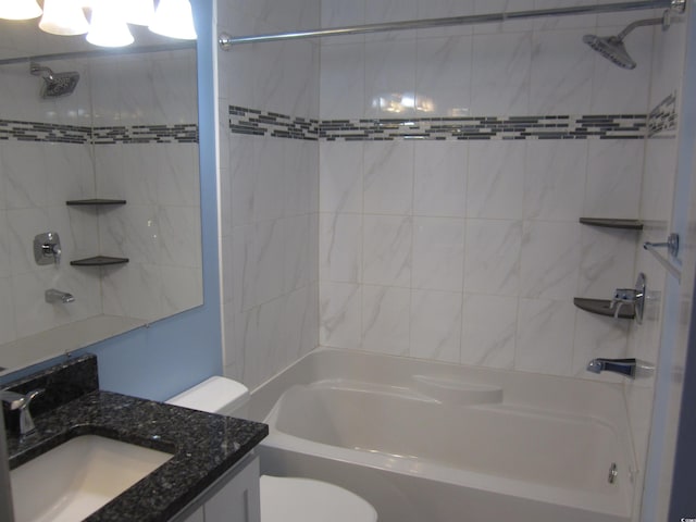 full bathroom with vanity, tiled shower / bath combo, and toilet