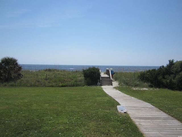 view of community featuring a water view and a lawn