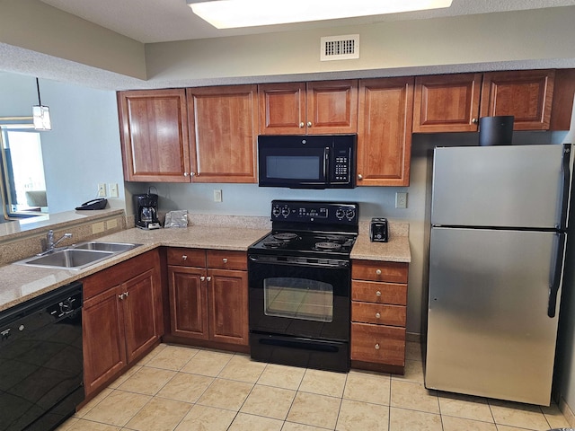 kitchen with black appliances, light tile patterned floors, sink, and hanging light fixtures