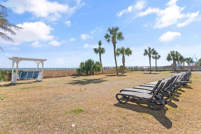 view of yard featuring a pergola and a water view