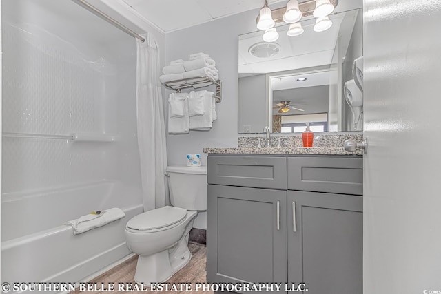 full bathroom featuring hardwood / wood-style flooring, shower / bathtub combination with curtain, ceiling fan, vanity, and toilet