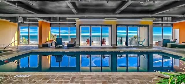 view of swimming pool with a water view