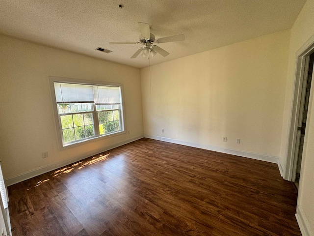 spare room featuring ceiling fan, dark hardwood / wood-style flooring, and a textured ceiling