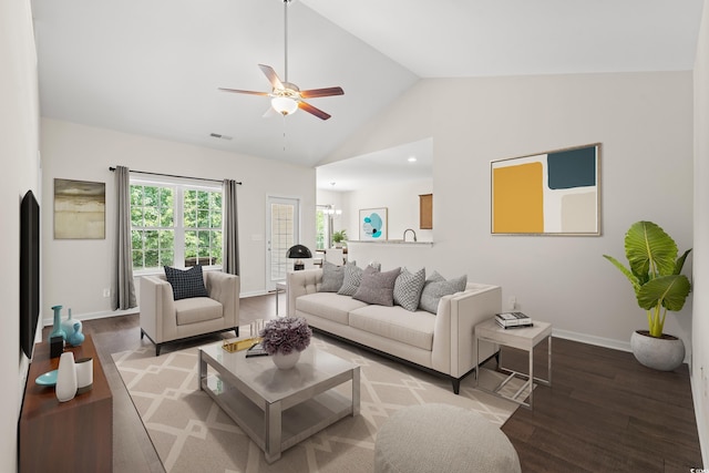 living room with hardwood / wood-style flooring, high vaulted ceiling, and ceiling fan with notable chandelier