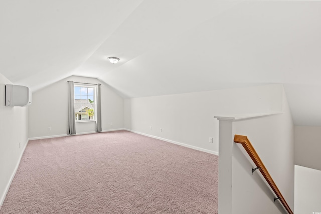 bonus room featuring vaulted ceiling, a wall unit AC, and carpet flooring