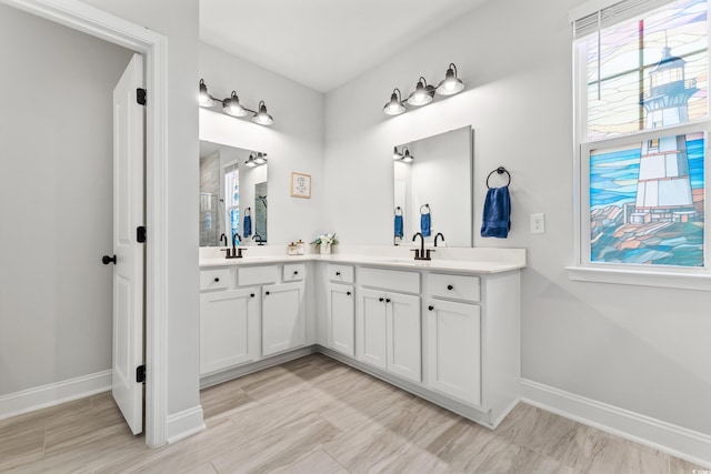 bathroom with tile patterned flooring and dual bowl vanity