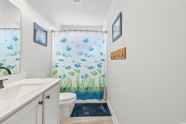 bathroom with tile patterned floors, toilet, and vanity