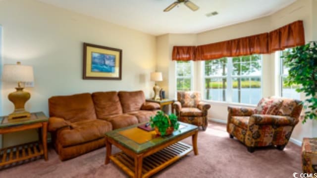 living room featuring carpet floors and ceiling fan