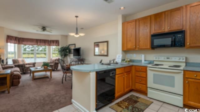 kitchen with ceiling fan with notable chandelier, light tile patterned floors, sink, kitchen peninsula, and black appliances