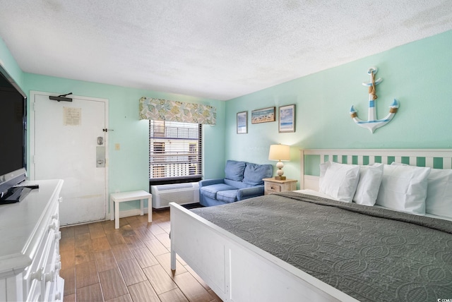 bedroom with a textured ceiling and hardwood / wood-style floors