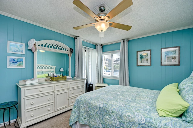 carpeted bedroom with a textured ceiling, ceiling fan, and crown molding