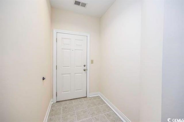 entryway with light tile patterned flooring