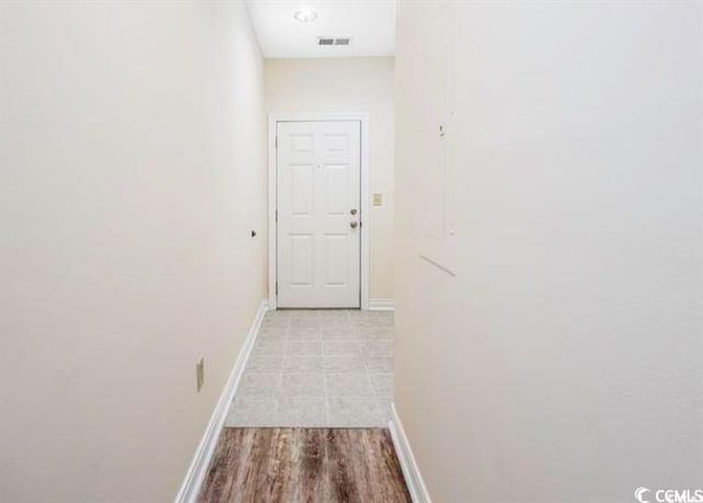 hall with light hardwood / wood-style floors