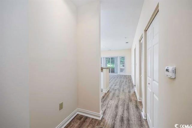 corridor with hardwood / wood-style flooring