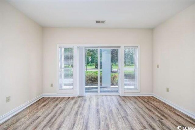 spare room with light hardwood / wood-style floors