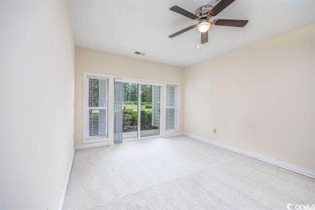 spare room with ceiling fan and light colored carpet