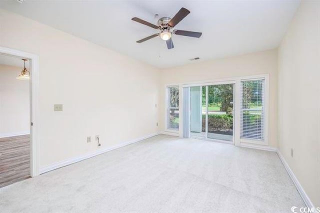 unfurnished room with ceiling fan and light carpet