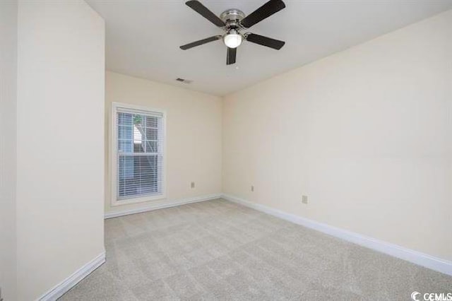 carpeted spare room featuring ceiling fan