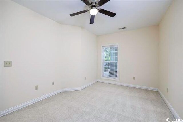 carpeted spare room with ceiling fan