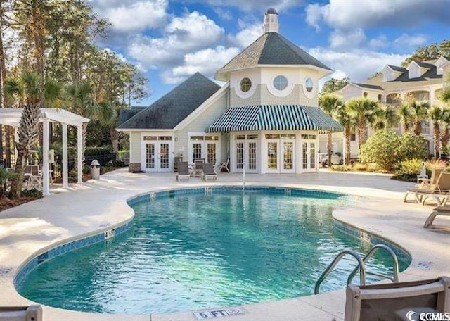 view of pool featuring a patio area and french doors