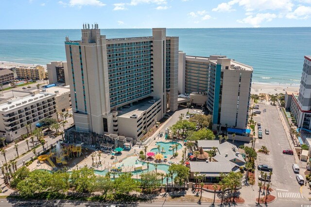 birds eye view of property featuring a water view and a beach view