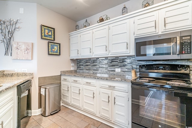 kitchen featuring black appliances, light tile patterned flooring, backsplash, and white cabinets