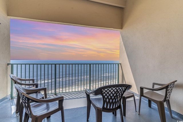 balcony featuring a water view and a view of the beach