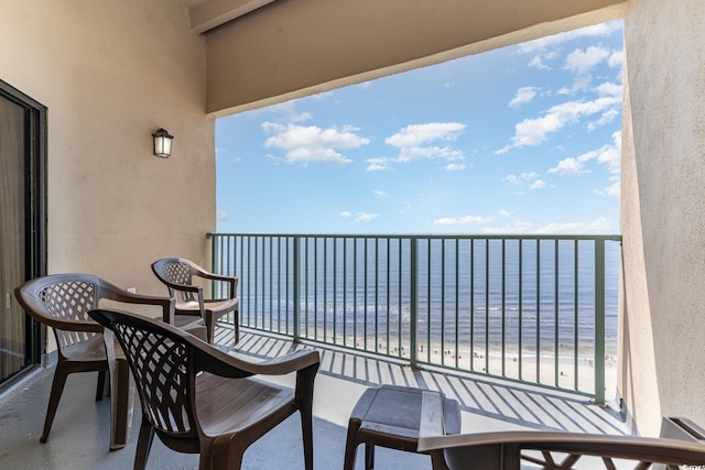 balcony with a water view and a beach view