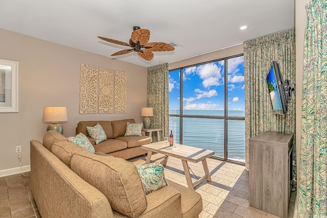 living area featuring recessed lighting, ceiling fan, and baseboards