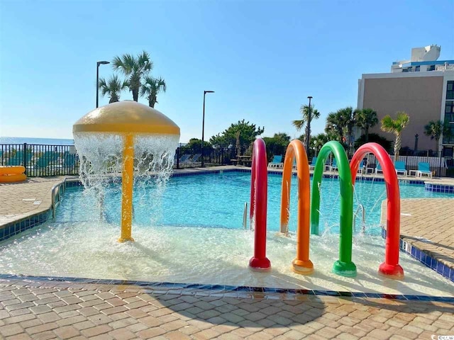 view of pool featuring fence