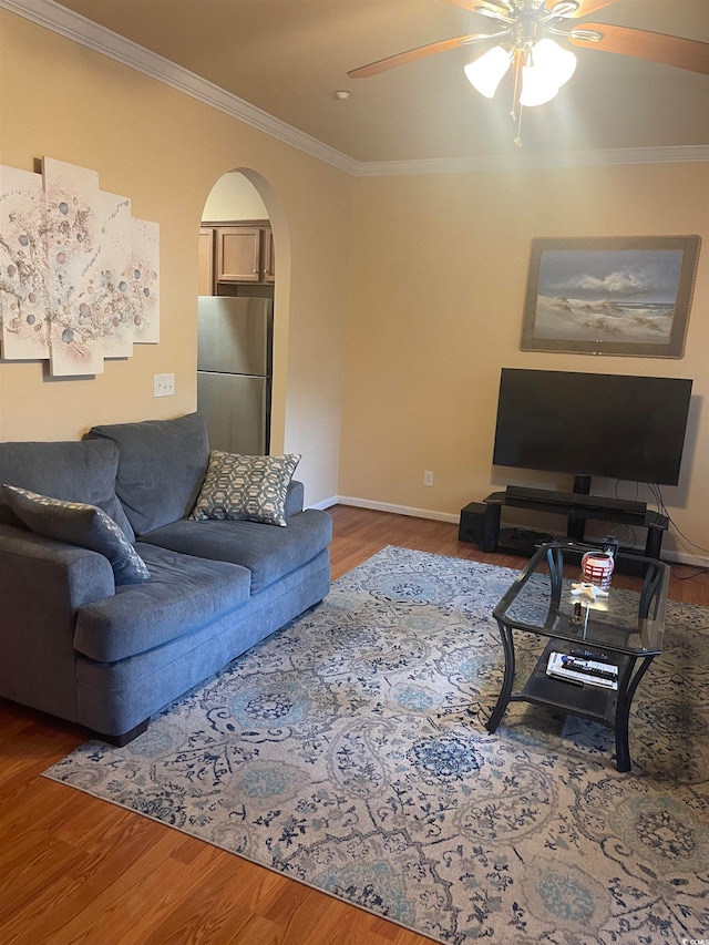 living room with ceiling fan, hardwood / wood-style flooring, and ornamental molding