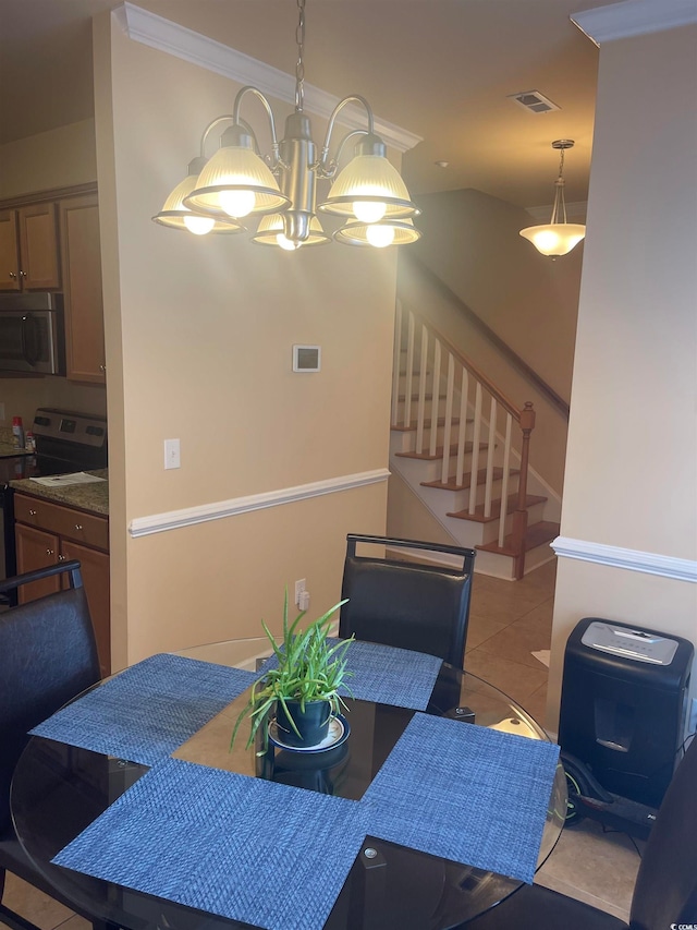 tiled dining room featuring crown molding and a chandelier