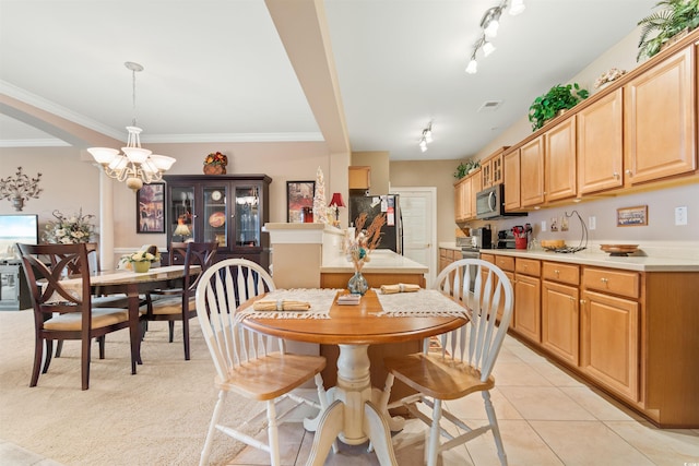 dining area featuring ornamental molding, a notable chandelier, and light tile patterned floors