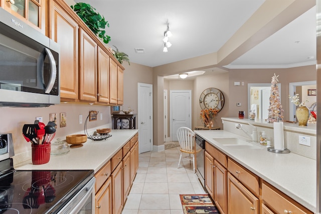 kitchen featuring ornamental molding, light tile patterned floors, stainless steel appliances, and sink