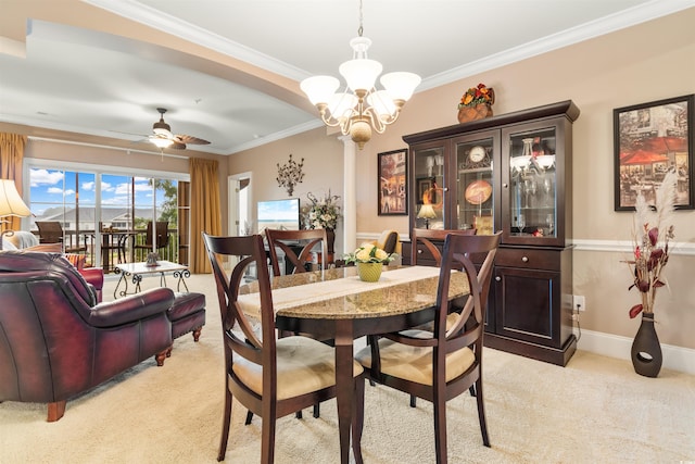 carpeted dining area featuring ceiling fan with notable chandelier and crown molding