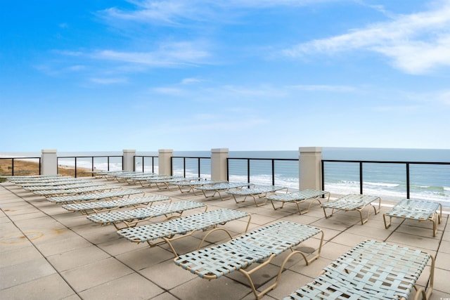 view of patio with a view of the beach and a water view