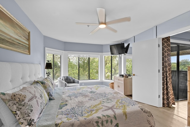 bedroom with access to exterior, light hardwood / wood-style flooring, and ceiling fan