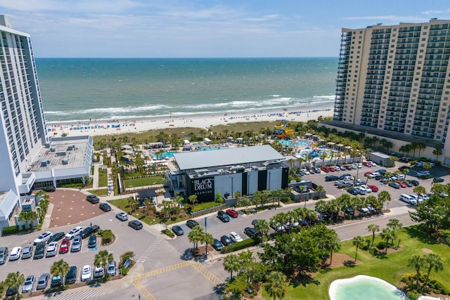 aerial view with a water view and a beach view