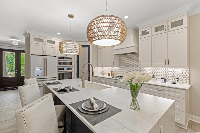 405 N Highland Way, Myrtle Beach, SC 29572 - kitchen featuring a sink, pendant lighting, light stone counters, a kitchen island with sink, and decorative backsplash