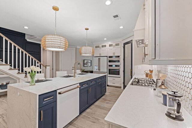 405 N Highland Way, Myrtle Beach, SC 29572 - kitchen featuring white appliances, a sink, blue cabinets, a kitchen island with sink, and recessed lighting