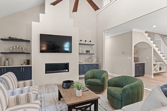 405 N Highland Way, Myrtle Beach, SC 29572 - living room with a ceiling fan, light wood-style flooring, high vaulted ceiling, stairway, and built in features