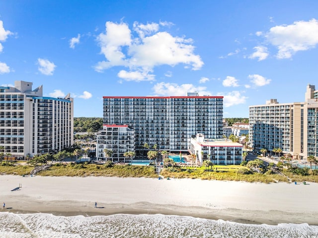 drone / aerial view with a beach view and a water view