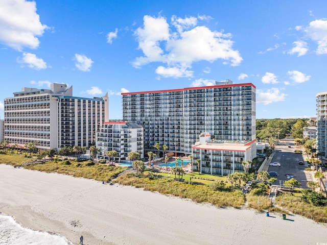 view of property featuring a beach view and a pool