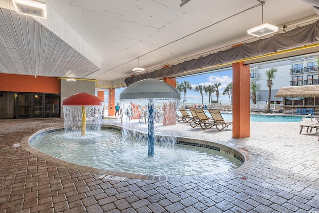 view of pool with pool water feature and a patio area