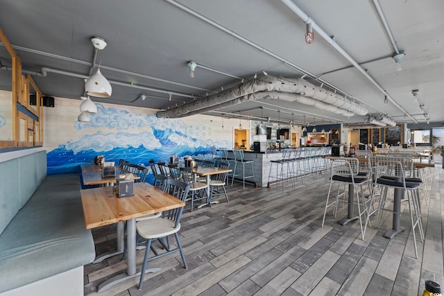 dining space with hardwood / wood-style flooring