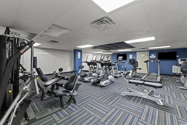 workout area with a drop ceiling and carpet floors