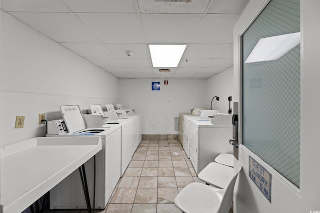 washroom featuring light tile patterned flooring and washer and clothes dryer