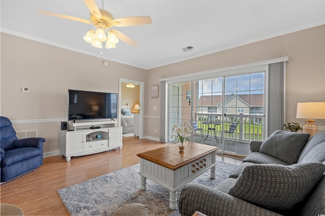 living room with ceiling fan, ornamental molding, and hardwood / wood-style flooring